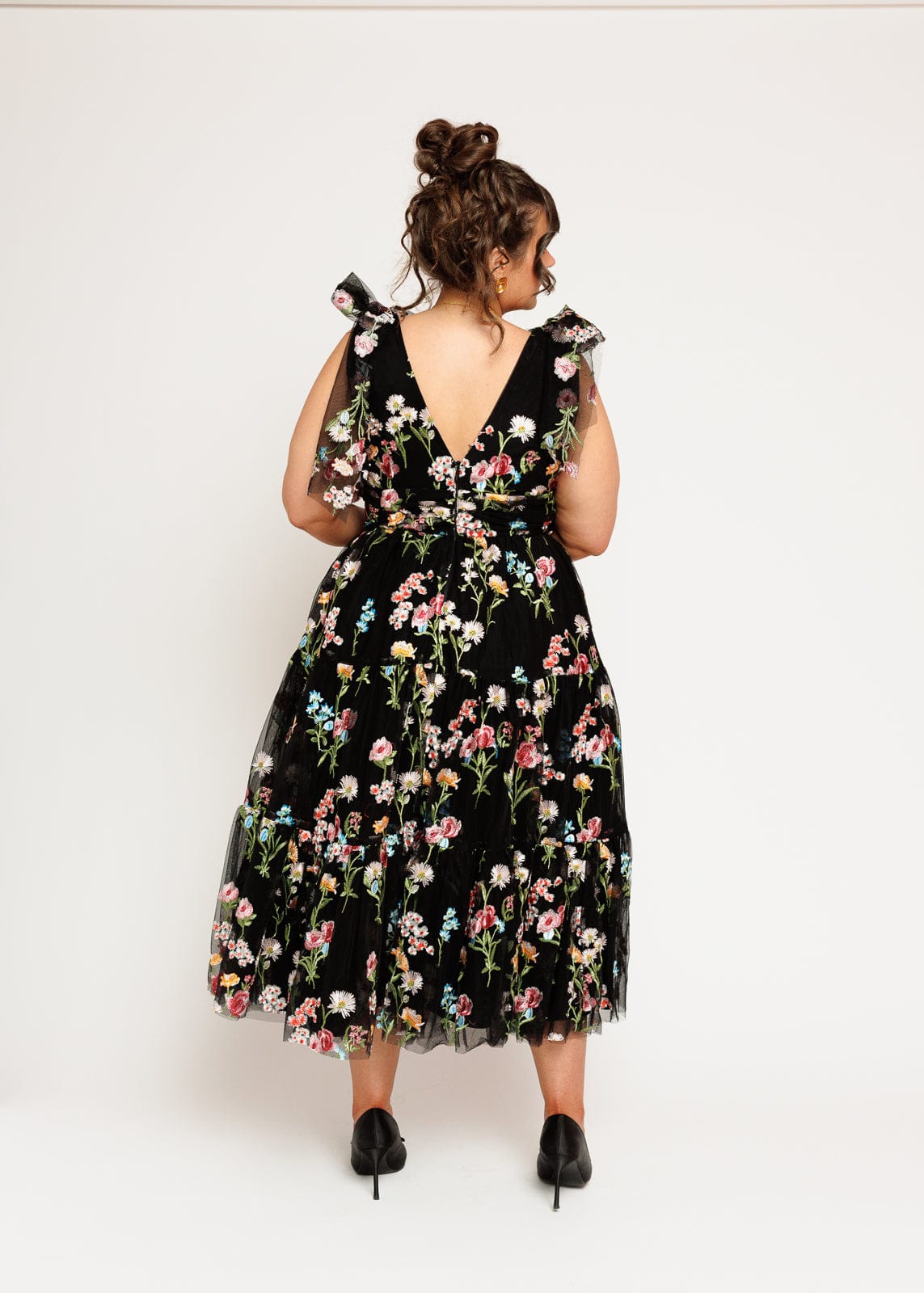 chic size inclusive model wearing JessaKae Margaret Floral Embroidered Midi Dress Black Dresses